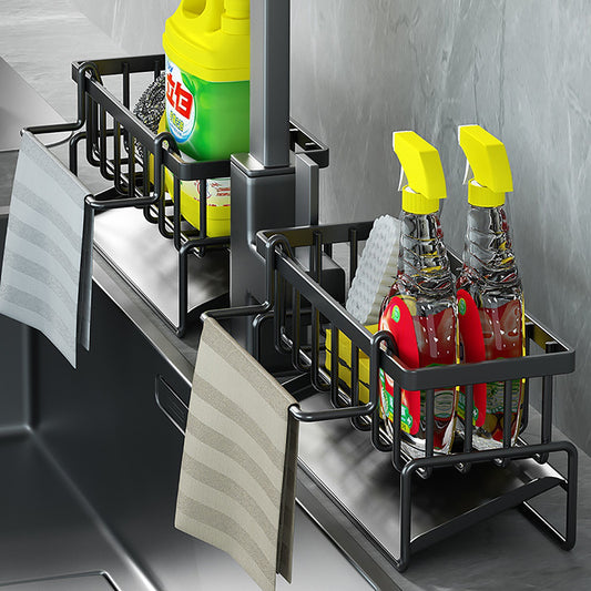 Black sink caddies holding cleaning supplies beside a kitchen tap