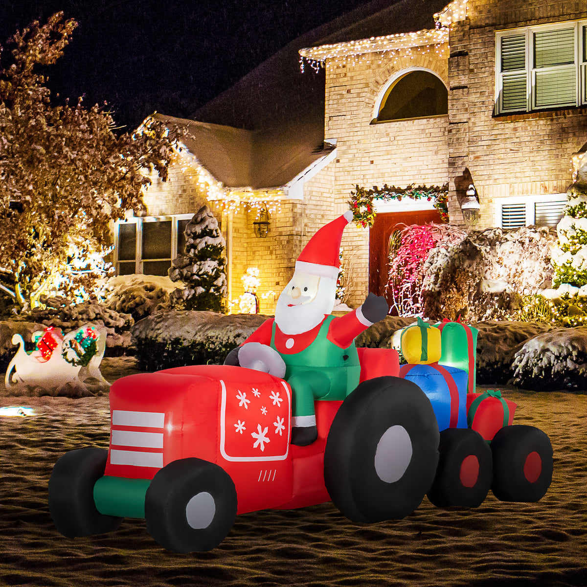 Santa tractor and trailer lit outside a house