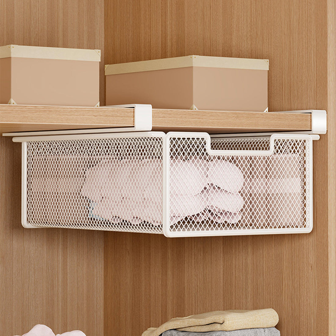 White under-shelf basket in a clothing cabinet